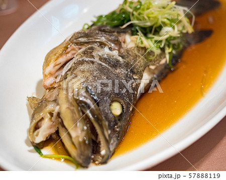 Fish in soy sauce, served on white plate 57888119