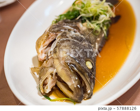 Fish in soy sauce, served on white plate Fish in soy sauce, served on white plate 57888126