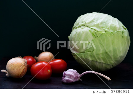 Raw vegetables on dark background Raw vegetables on dark background 57896911