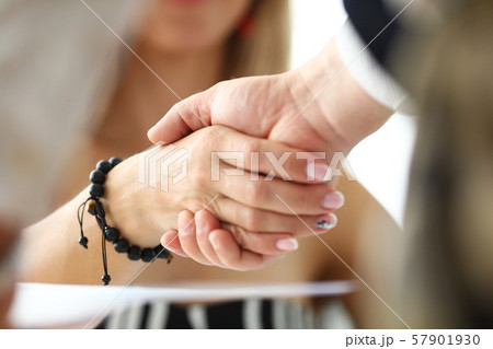 Man and woman shaking hands as symbol for positive prospects 57901930