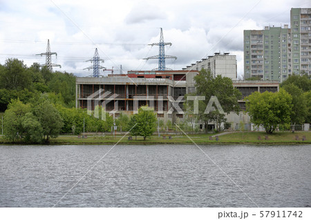 Unfinished building near the water in cloudy Unfinished building near the water in cloudy 57911742