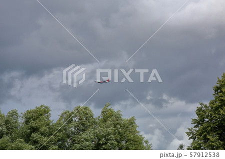 Passenger aircraft in the gray cloudy sky Passenger aircraft in the gray cloudy sky 57912538