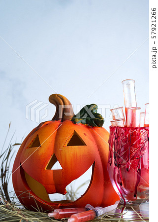 Halloween bloody glass with test tubes of tomato juice and with pumpkin jack . Party drinks on dry 57921266