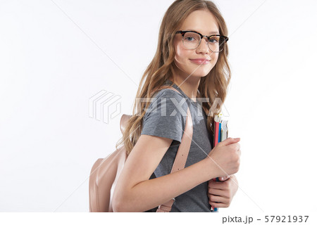 Beautiful teen girl in glasses holding books 57921937