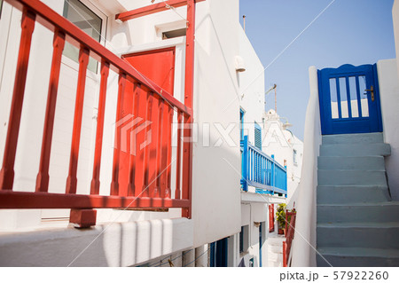 The narrow streets of the island with blue balconies, stairs and flowers. The narrow streets of the island with blue balconies, stairs and flowers. 57922260