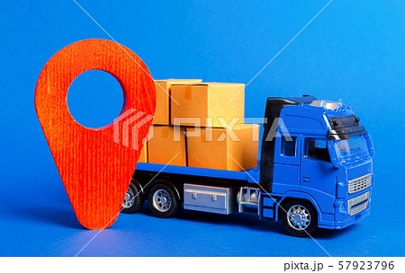 A blue truck loaded with boxes and a red pointer location. Services transportation of goods, products, logistics and infrastructure. Transportation company. Location of carriers. Package tracking A blue truck loaded with boxes and a red pointer location. Services transportation of goods, products, logistics and infrastructure. Transportation company. Location of carriers. Package tracking 57923796