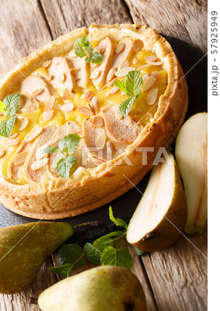 Pear tart with almonds and mint closeup on a slate 57925949