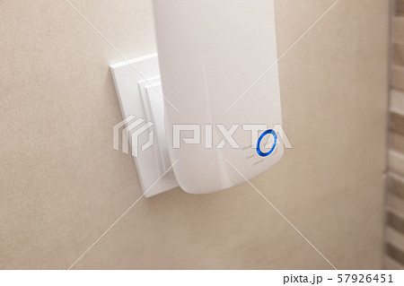 Wifi home repeater plugged in closeup. 57926451