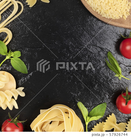 Italian food design template. Pasta, tomatoes and basil, a flat lay frame Italian food design template. Pasta, tomatoes and basil, a flat lay frame 57926744