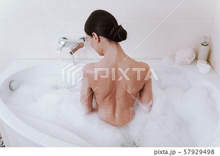 Rear view of a nude woman taking shower Rear view of a nude woman taking shower 57929498