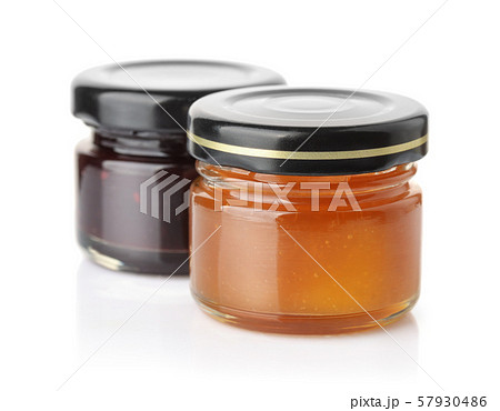 Small glass jars of apricot and blueberry jam 57930486