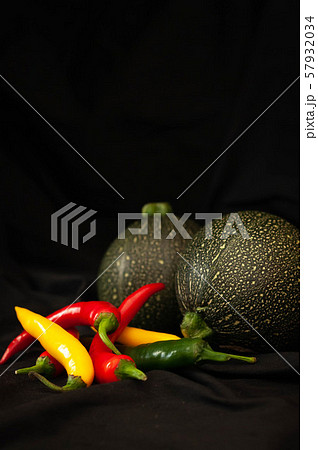 round courgettes and bright hot peppers 57932034