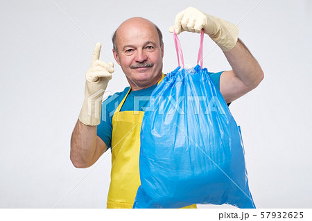 spanish man with rubbish bag pointing finger up spanish man with rubbish bag pointing finger up 57932625