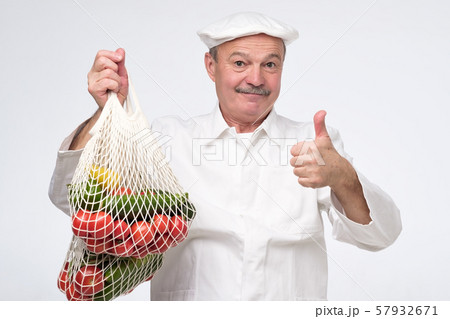 Cook chef holding white eco cotton string bag Cook chef holding white eco cotton string bag 57932671