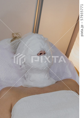 Woman lying on a couch in a beauty parlor with a 57935771