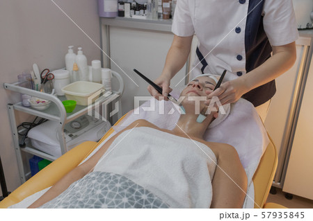 Professional beautician does the procedure for a 57935845