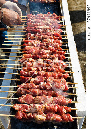 Marinated meat is roasted on the coals in the barbecue 57941945