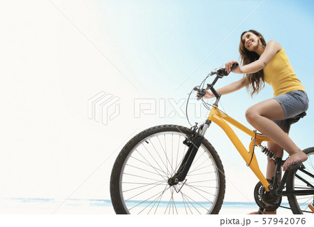 Young woman riding bicycle 57942076