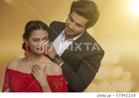 Man putting necklace on wife 57942239