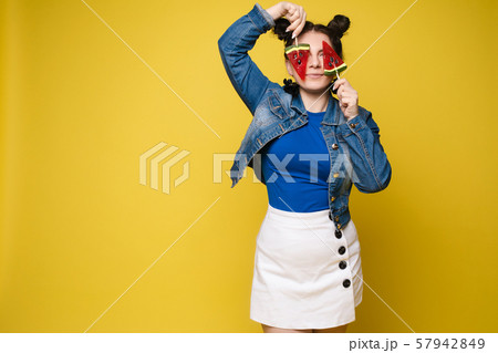 Funny girl with lollipops on eyes and open mouth. 57942849