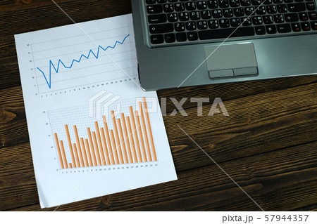 Notebook laptop computer and financial graph on Notebook laptop computer and financial graph on 57944357