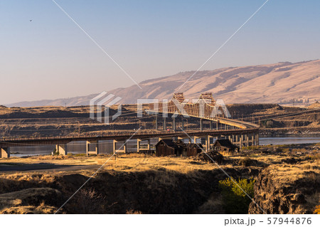 Sunset view of The Dalles bridge over the Columbia River that separates Washington and Oregon states 57944876
