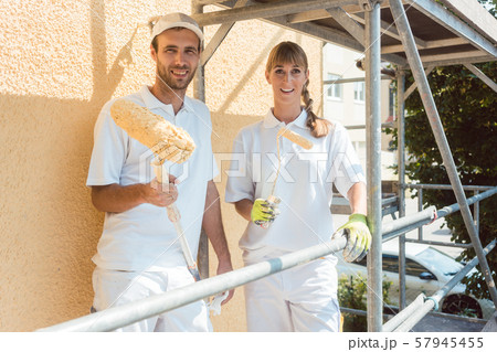 Two painters on scaffold looking into the camera Two painters on scaffold looking into the camera 57945455