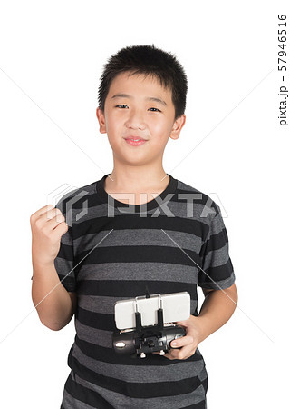 Successful happy Asian boy holding radio remote Successful happy Asian boy holding radio remote 57946516