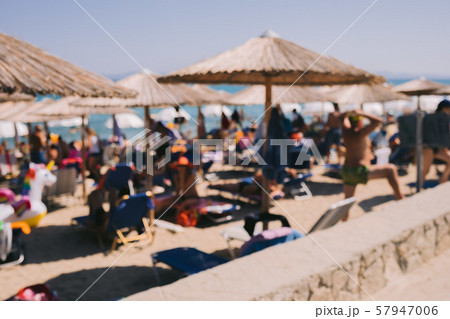 blur background of sun beds under umbrellas 57947006