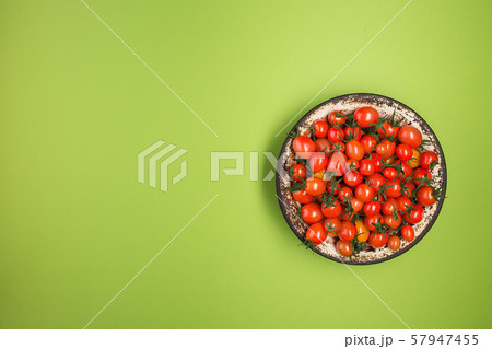 Flat lay with red tomatoes on green background. Flat lay with red tomatoes on green background. 57947455