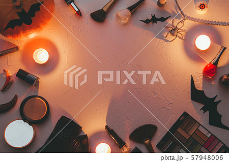Photo of shadows, brushes, halloween spider, ghost, candles on blank black background. 57948006