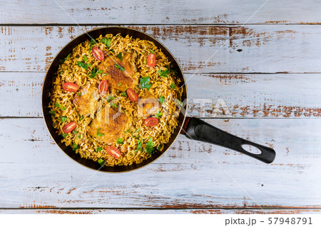 Asian rice and pasta with chicken and vegetables. 57948791