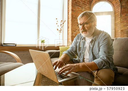 Senior man working with laptop at home - concept of home studying Senior man working with laptop at home - concept of home studying 57950923