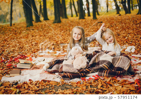 Cute little girls in a autumn park Cute little girls in a autumn park 57951174