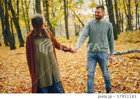 Beautiful couple spend time in a autumn park 57951183