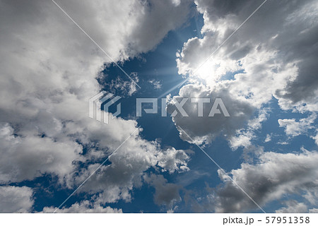 Blue sky with clouds and sun rays - Background 57951358