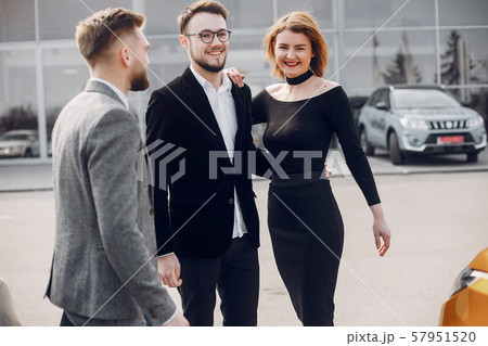 Stylish and elegant couple in a car salon 57951520