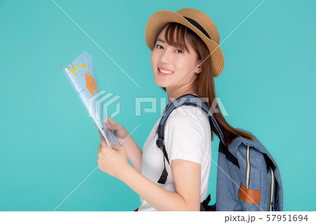 Beautiful happy young asian woman travel holding and looking a paper map isolated 57951694