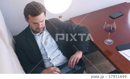 Businessman works on private plane 57951699