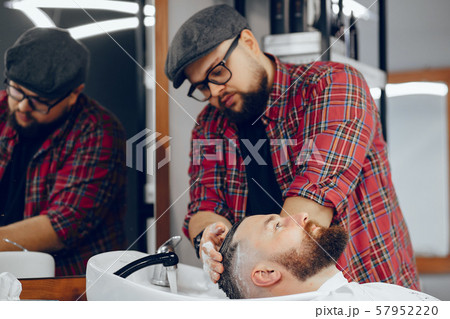 Stylish man sitting in a barbershop Stylish man sitting in a barbershop 57952220
