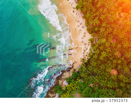 Romantic sunset on a tropical beach with palm trees Romantic sunset on a tropical beach with palm trees 57952373
