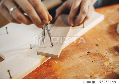 The carpenter works with a tree 57953149