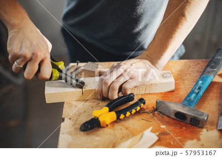 The carpenter works with a tree 57953167