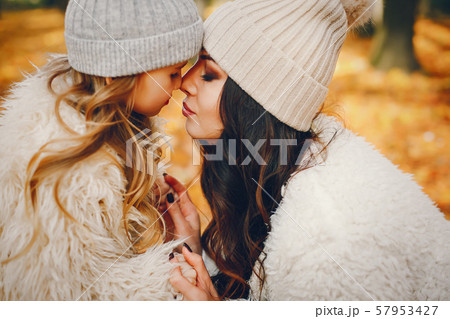 Cute and stylish family in a autumn park 57953427