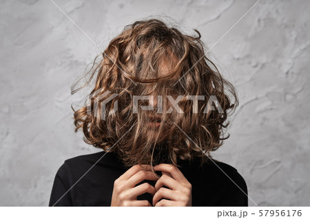 Closeup portrait of young lady with disheveled 57956176