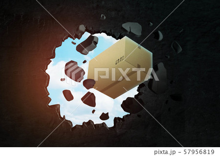 3d rendering of closed cardboard box breaking black wall 3d rendering of closed cardboard box breaking black wall 57956819