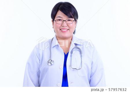 Face of happy overweight Asian woman doctor smiling Face of happy overweight Asian woman doctor smiling 57957632