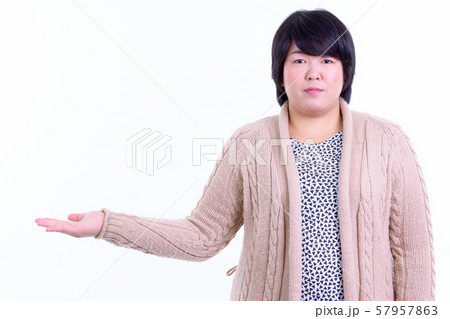 Beautiful overweight Asian woman showing something ready for winter Beautiful overweight Asian woman showing something ready for winter 57957863