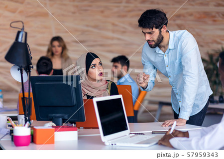 Multiethnic startup business team on meeting in modern bright office interior brainstorming, working Multiethnic startup business team on meeting in modern bright office interior brainstorming, working 57959343