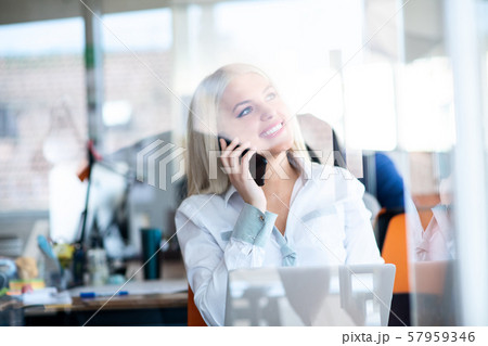 business concept - businesswoman talking on the phone in office business concept - businesswoman talking on the phone in office 57959346